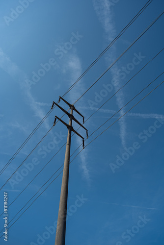 Wallpaper Mural High voltage power line pole in a field. Low angle show, blue sky in the background, no people Torontodigital.ca