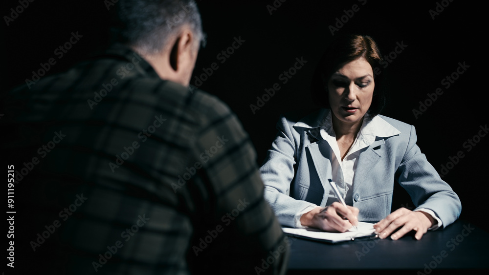 Woman lawyer writing down details of the offense to build a line of defense for the jury in court Woman lawyer writing down details of the offense to build a line of defense for the jury in court