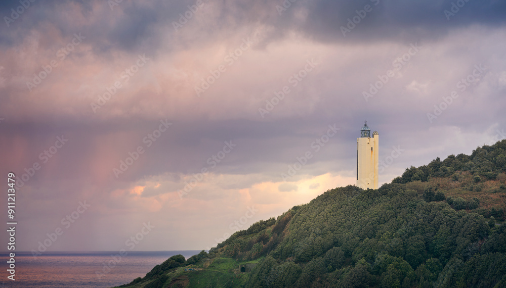 Sunset with the sky loaded with storm clouds at the Gorliz lighthouse, Bizkaia Sunset with the sky loaded with storm clouds at the Gorliz lighthouse, Bizkaia