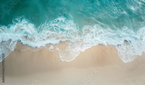 Aerial view of the sandy beach and sea waves, with an ocean background