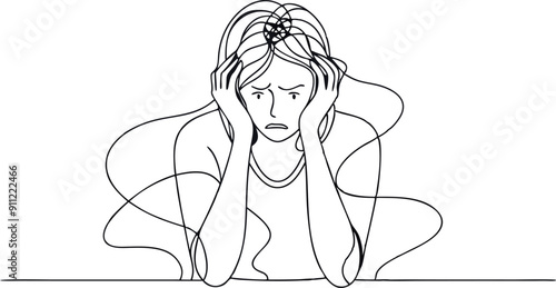 A woman is sitting at a table with her head in her hands. She looks sad and is probably feeling overwhelmed or stressed