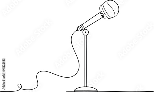 A microphone is on a stand with a microphone cord trailing behind it
