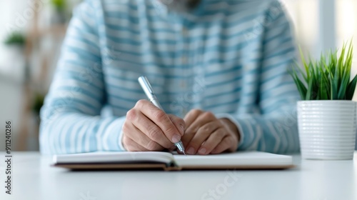 Obraz na płótnie A man with a notebook, jotting down notes while taking an online certification exam w salonie