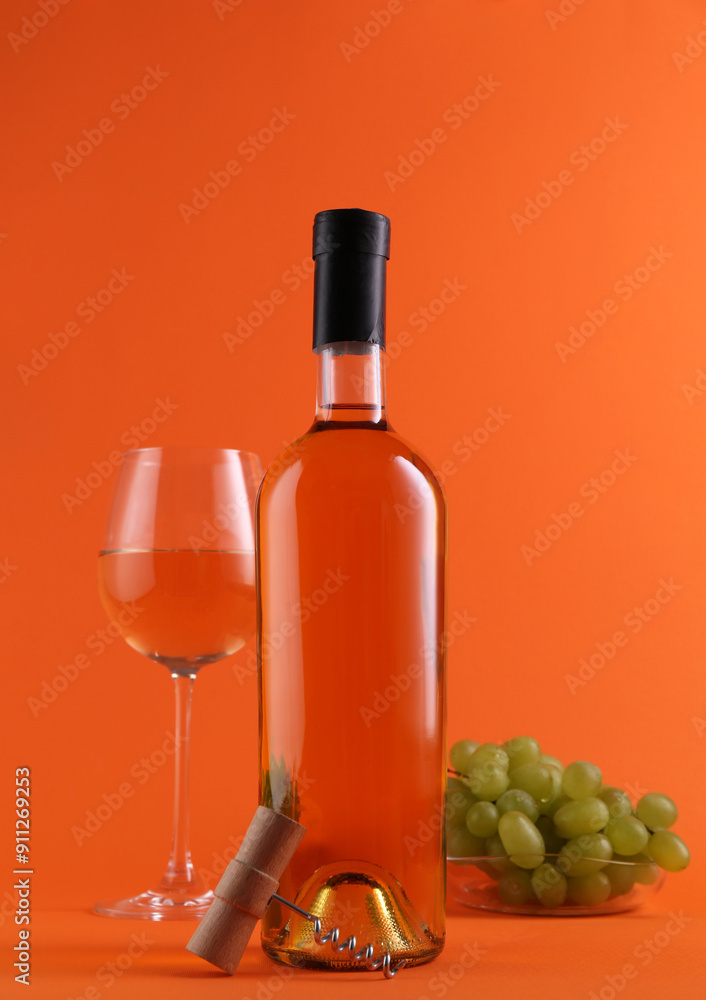 Obraz premium Wine, corkscrew and fresh grapes on orange background