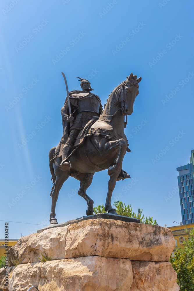 Fototapeta premium Tirana, Albania 07-16-2024 The Skanderbeg Monument is a monument in the Skanderbeg Square in Tirana. It commemorates Skanderbeg, the national hero in Albania for resisting the Ottomans