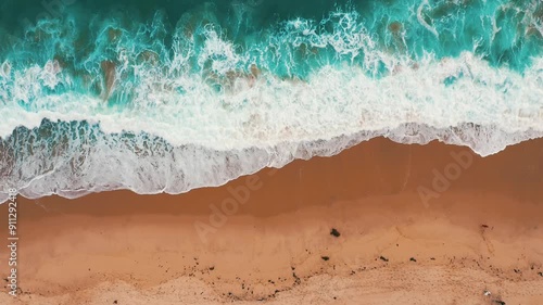 top view Beautiful topical beach with white sand. Top view empty and clean beach. Waves crashing beach from above. With people walk and relax on the beach