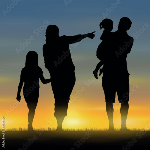 Parents walking with two daughter outdoor on grass field at evening during sunset silhouette.