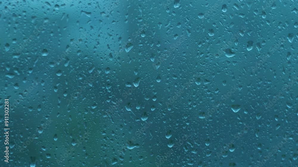 raindrops on window glass in heavy rain outside, bad weather and strong wind with rain outside the window on a summer day, selective focus raindrops on window glass in heavy rain outside, bad weather and strong wind with rain outside the window on a summer day, selective focus