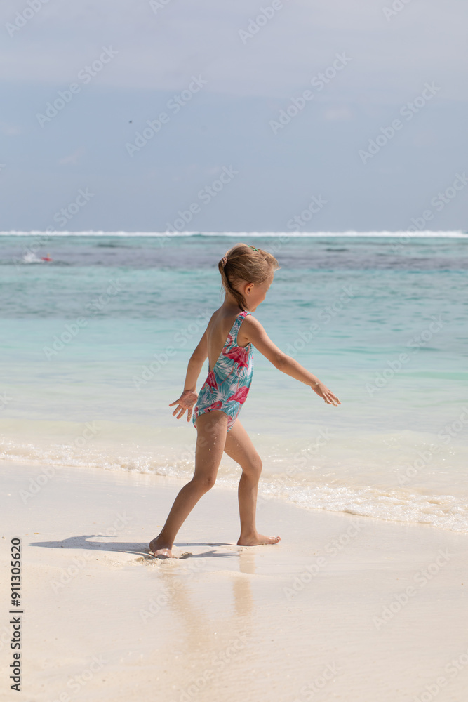 Girl swims in the ocean, summer vacation, vitamin D, vacation with children Girl swims in the ocean, summer vacation, vitamin D, vacation with children