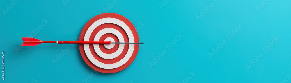Red dart hitting the center of a bullseye target on a vibrant blue background, symbolizing accuracy, precision, and goal achievement. Red dart hitting the center of a bullseye target on a vibrant blue background, symbolizing accuracy, precision, and goal achievement.