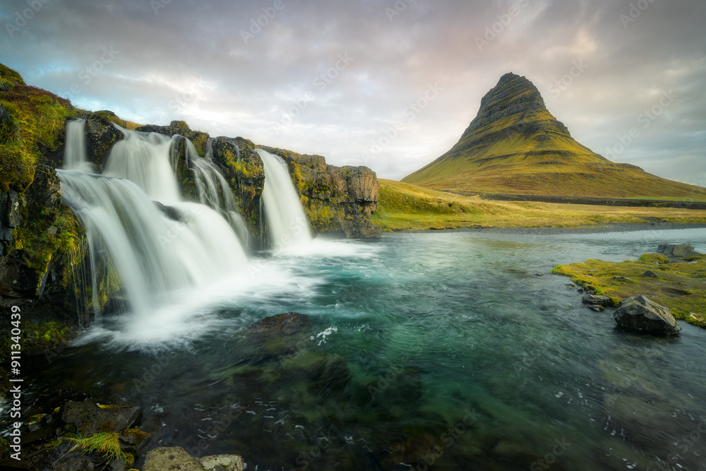 Kirkjufellfoss waterfall in Iceland with the iconic Kirkjufell mountain Kirkjufellfoss waterfall in Iceland with the iconic Kirkjufell mountain