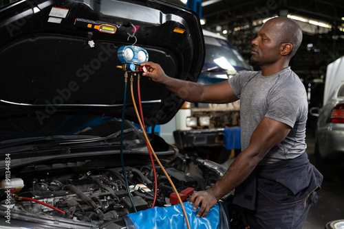 Fotografi mechanic worker fixing and checking a car air conditioning system in automobile