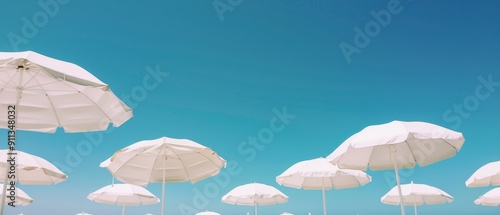 white beach umbrellas under clear blue sky