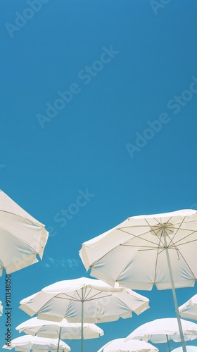 white beach umbrellas under clear blue sky