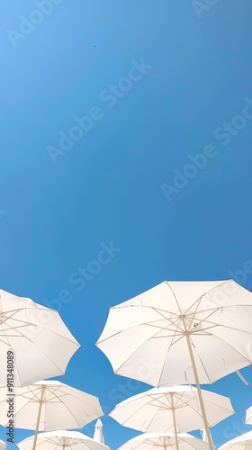white beach umbrellas under clear blue sky