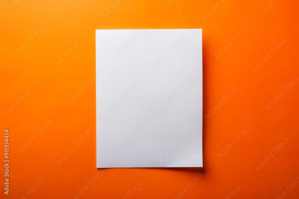 A lone human hand cradles a pristine white sheet of paper or card against a vibrant orange background, evoking creativity and artistic possibility. A lone human hand cradles a pristine white sheet of paper or card against a vibrant orange background, evoking creativity and artistic possibility.
