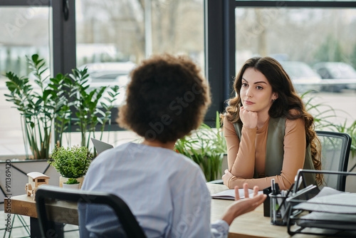 Colleagues share thoughtful conversation amidst office restructuring.