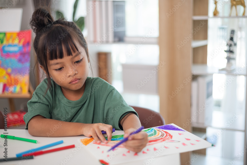 A young girl is sitting at a table with a pencil and a piece of paper in her hand. She is practicing drawing and coloring, honing her skills at home. A young girl is sitting at a table with a pencil and a piece of paper in her hand. She is practicing drawing and coloring, honing her skills at home.