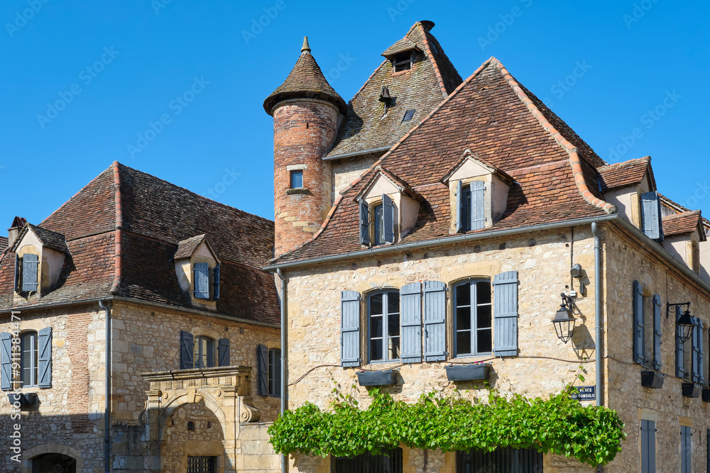 Houses near The Place des Consuls square in Bretenoux Lot Occitanie in Southern France on a sunny day in summer with a clear blue sky. Houses near The Place des Consuls square in Bretenoux Lot Occitanie in Southern France on a sunny day in summer with a clear blue sky.