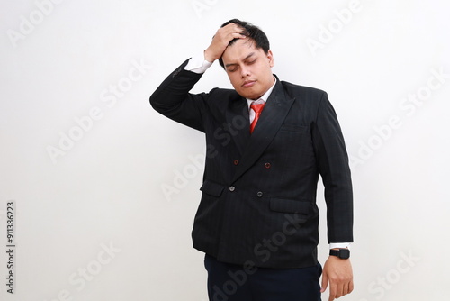 Studio portrait of tired frustrated businessman or office worker sighing and wiping sweat of forehead, has emotional burnout, exhausted by long work during hot weather in the office, isolated.