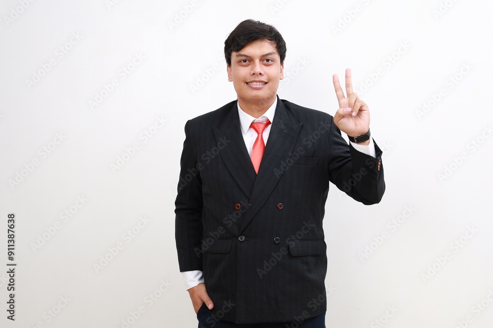 Young and handsome Asian businessman in a suit showing number two hand gestures. Young and handsome Asian businessman in a suit showing number two hand gestures.