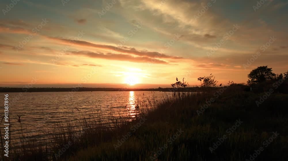 Sunset on the lake, sunlight and clouds. Slow motion Sunset on the lake, sunlight and clouds. Slow motion