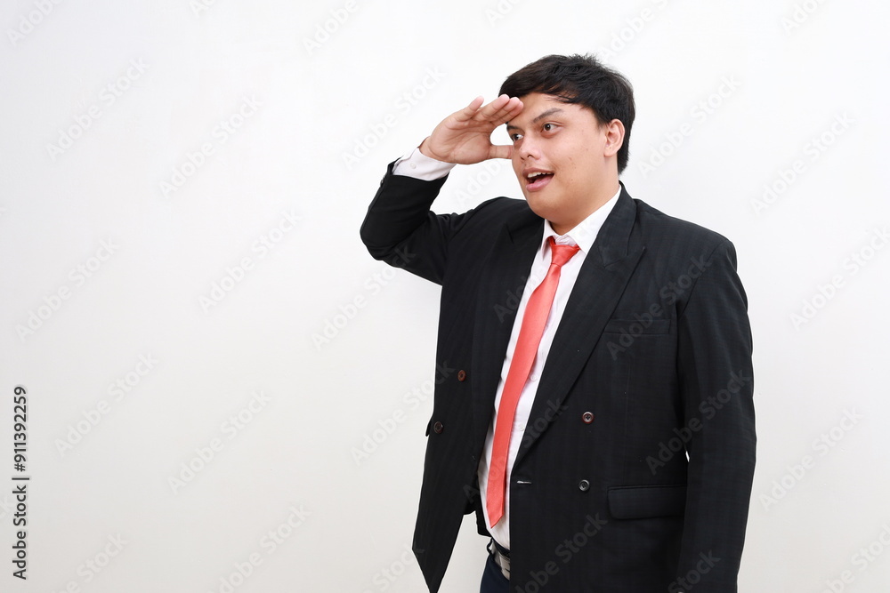Young asian successful employee businessman hold hand at forehead look far away distance isolated on white background Young asian successful employee businessman hold hand at forehead look far away distance isolated on white background