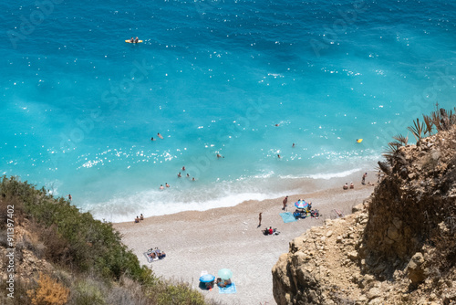 Beautiful beach with clear blue waters and white sand in Cala Moraig, Spain photo