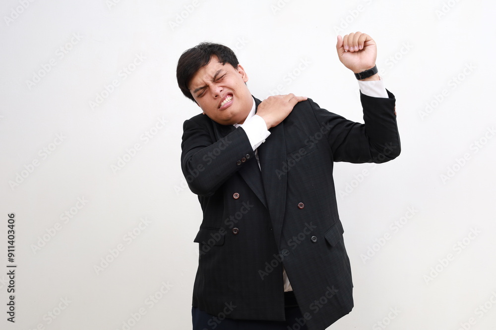 Asian worker businessman showing in pain gesture on his back shoulder. Isolated on white background Asian worker businessman showing in pain gesture on his back shoulder. Isolated on white background