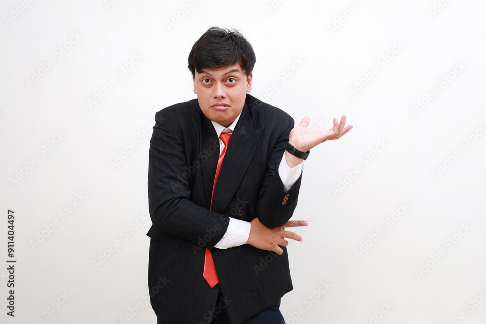 Displeased confused young asian businessman Spreading hands isolated on white wall background Displeased confused young asian businessman Spreading hands isolated on white wall background