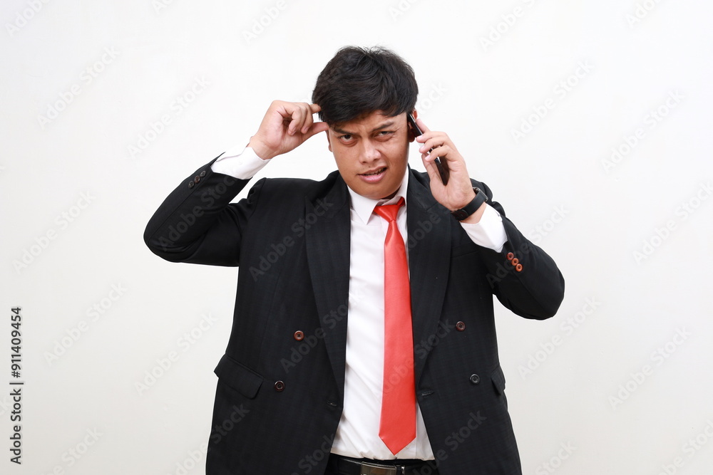 Stressed confused asian businessman having a phone call. Efficiency, planning and stress management concept Stressed confused asian businessman having a phone call. Efficiency, planning and stress management concept