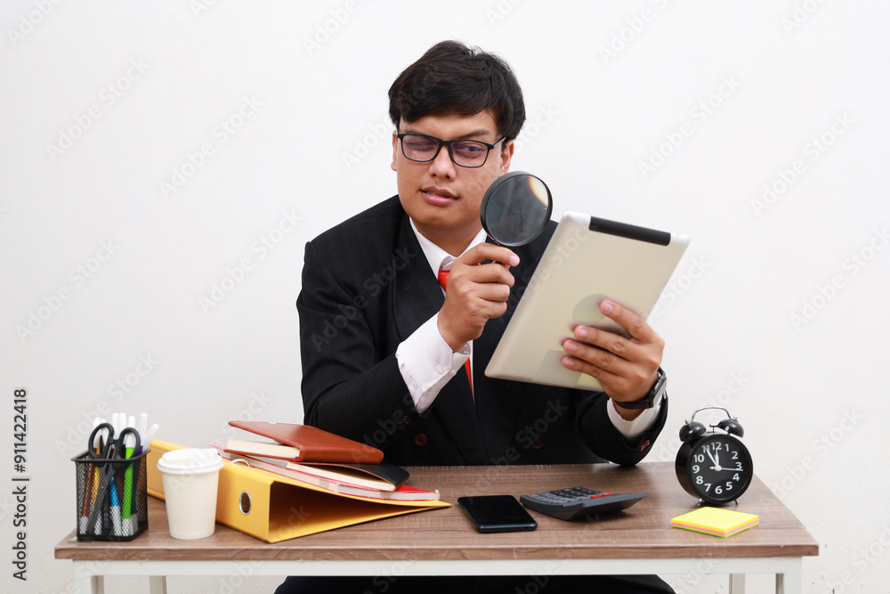 Curious man office worker looking at tablet computer display through magnifying glass, spying trying to find out private secure information, controlling internet connection. isolated on white Curious man office worker looking at tablet computer display through magnifying glass, spying trying to find out private secure information, controlling internet connection. isolated on white