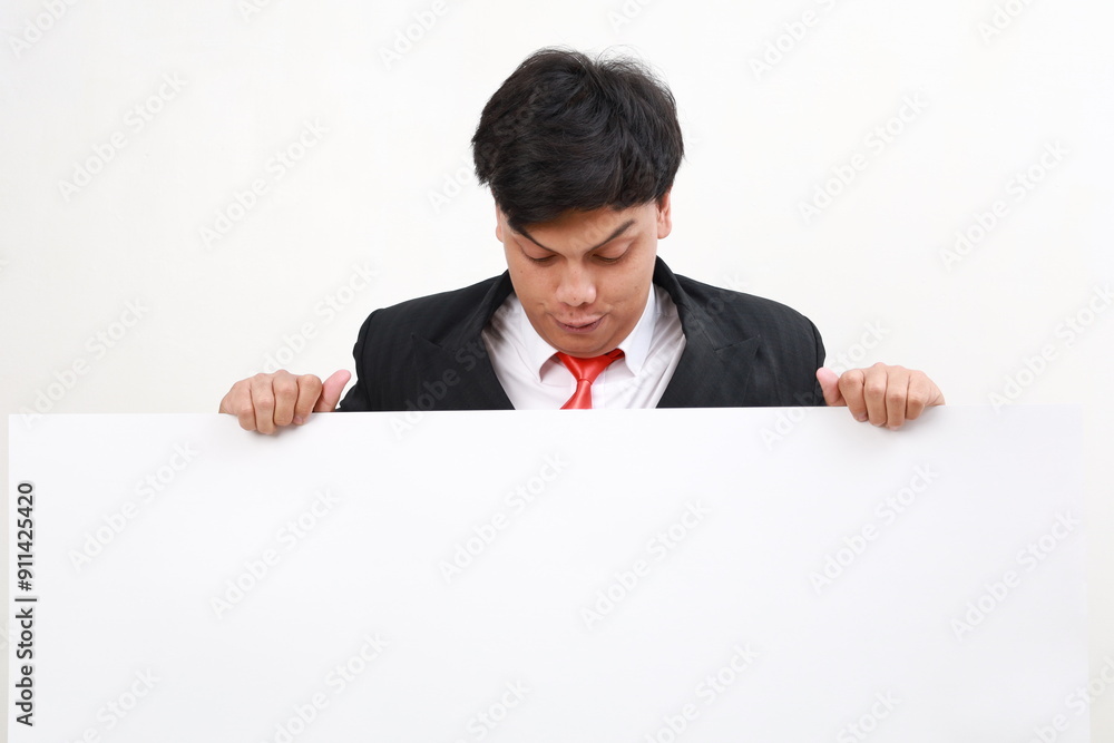 Happy Young asian businessman in formal suit holding blank mockup paper Happy Young asian businessman in formal suit holding blank mockup paper
