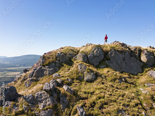 Mountaineer perched on top of Mt. Menditxuri, Navarrese Pyrenees photo