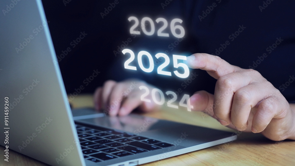 Businessman touch the number 2025 to change and enter the new year, merry christmas and happy new year.New year start concept. Businessman touch the number 2025 to change and enter the new year, merry christmas and happy new year.New year start concept.