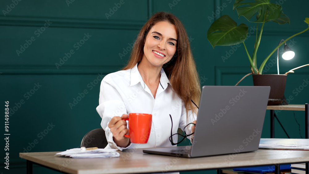 A self-assured professional woman excels in her modern office, exuding a sense of accomplishment and relaxation. Ideal for themes of job satisfaction, office success, and professional achievement. A self-assured professional woman excels in her modern office, exuding a sense of accomplishment and relaxation. Ideal for themes of job satisfaction, office success, and professional achievement.