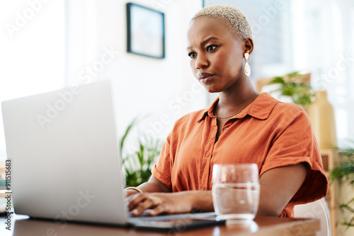 Typing, online and black woman with laptop, office and thinking of ideas and copywriting. Writer, working and creative for website on desk, seriously and confident in company and reading of person