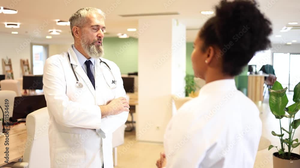 Doctor advising younger female colleague Doctor advising younger female colleague