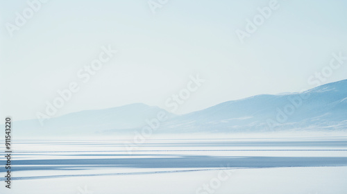 A snowy landscape with a mountain in the background