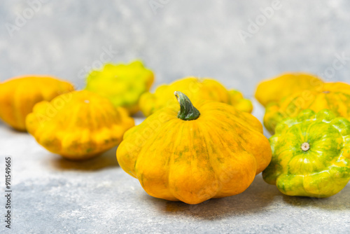 Pattypan zucchini on a textured kitchen table. squash. Fresh organic pattypan squashes on background. Vegan. Farmer's Market. Patisson. Space for text. Copy space. photo