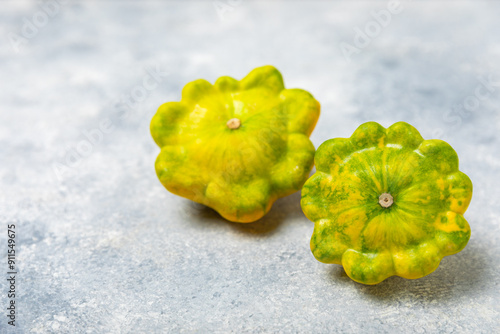 Pattypan zucchini on a textured kitchen table. squash. Fresh organic pattypan squashes on background. Vegan. Farmer's Market. Patisson. Space for text. Copy space. photo