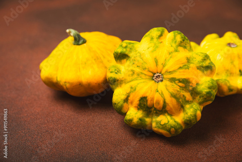 Pattypan zucchini on a textured kitchen table. squash. Fresh organic pattypan squashes on background. Vegan. Farmer's Market. Patisson. Space for text. Copy space. photo