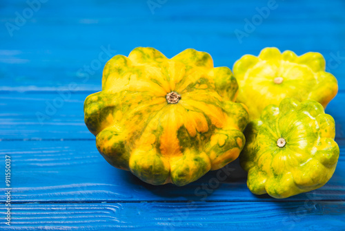 Pattypan zucchini on a textured kitchen table. squash. Fresh organic pattypan squashes on background. Vegan. Farmer's Market. Patisson. Space for text. Copy space. photo