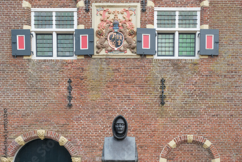 detail of  weigh house from year 1650 with statue of monk Uffing in Workum, which is  one of the Eleven Cities of Friesland in The  Netherlands photo