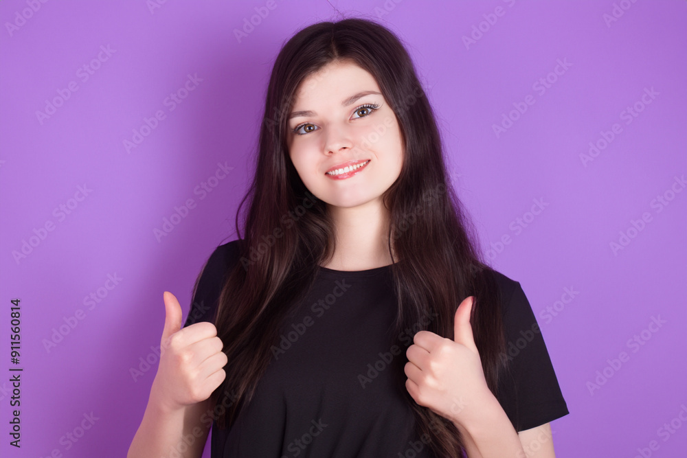 Girl in purple thumbs up on . female woman gesture concept. a girl thumbs up in purple on a . a girl thumbs up in purple against a lifestyle blue. Girl in purple thumbs up on . female woman gesture concept. a girl thumbs up in purple on a . a girl thumbs up in purple against a lifestyle blue.