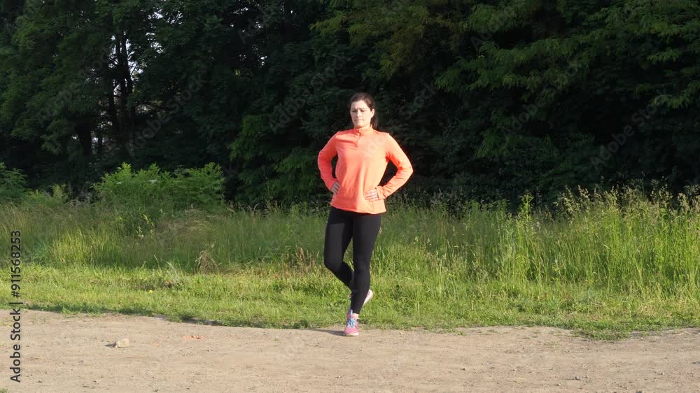 Woman makes exersices in the morning before jogging Woman makes exersices in the morning before jogging