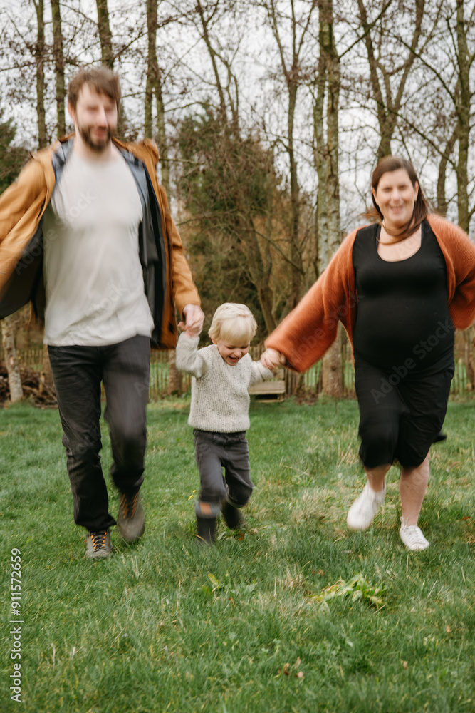 Family running through a field Family running through a field