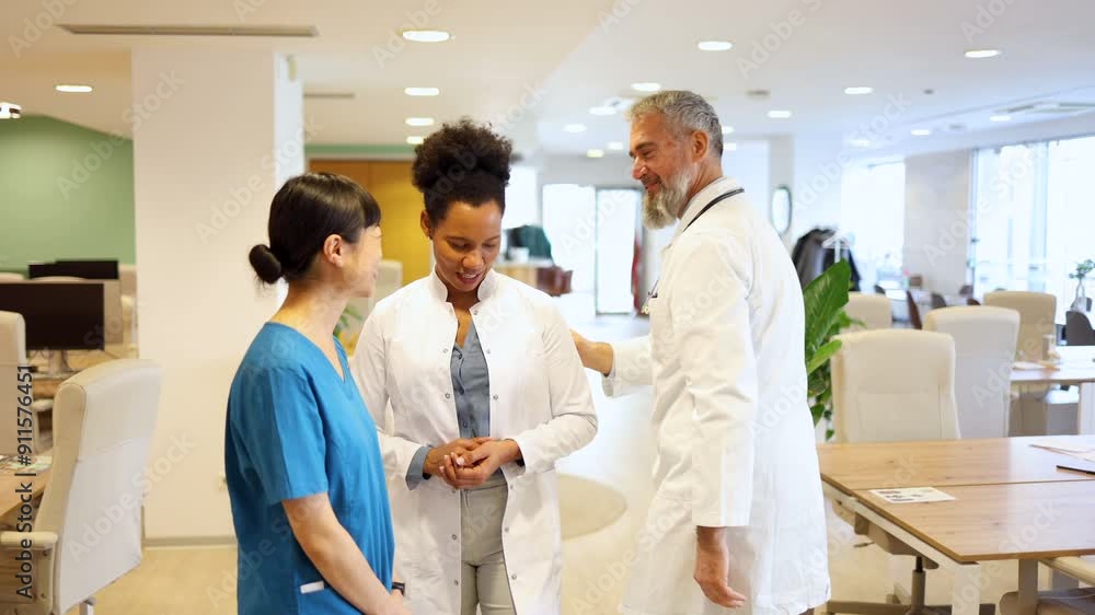 African American female doctor chatting with an Asian nurse during a break African American female doctor chatting with an Asian nurse during a break