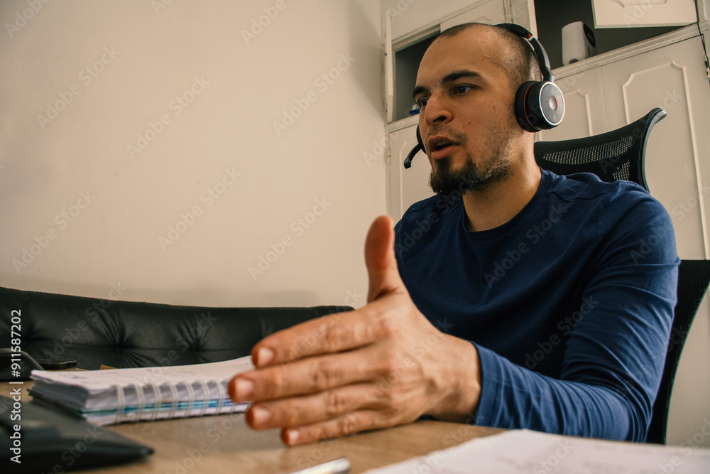 Man Working from Home Office with Headphones in Virtual Meeting Man Working from Home Office with Headphones in Virtual Meeting