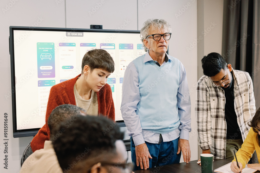Diverse multigenerational team engaging project meeting Diverse multigenerational team engaging project meeting